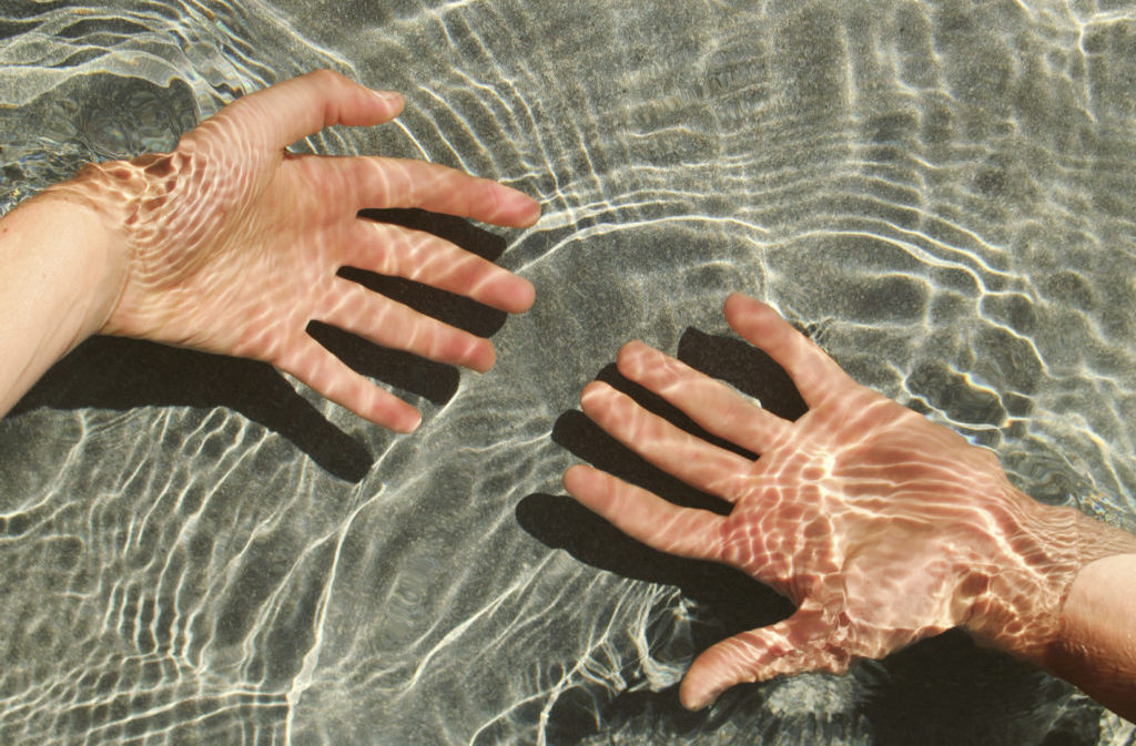 Hands floating under water